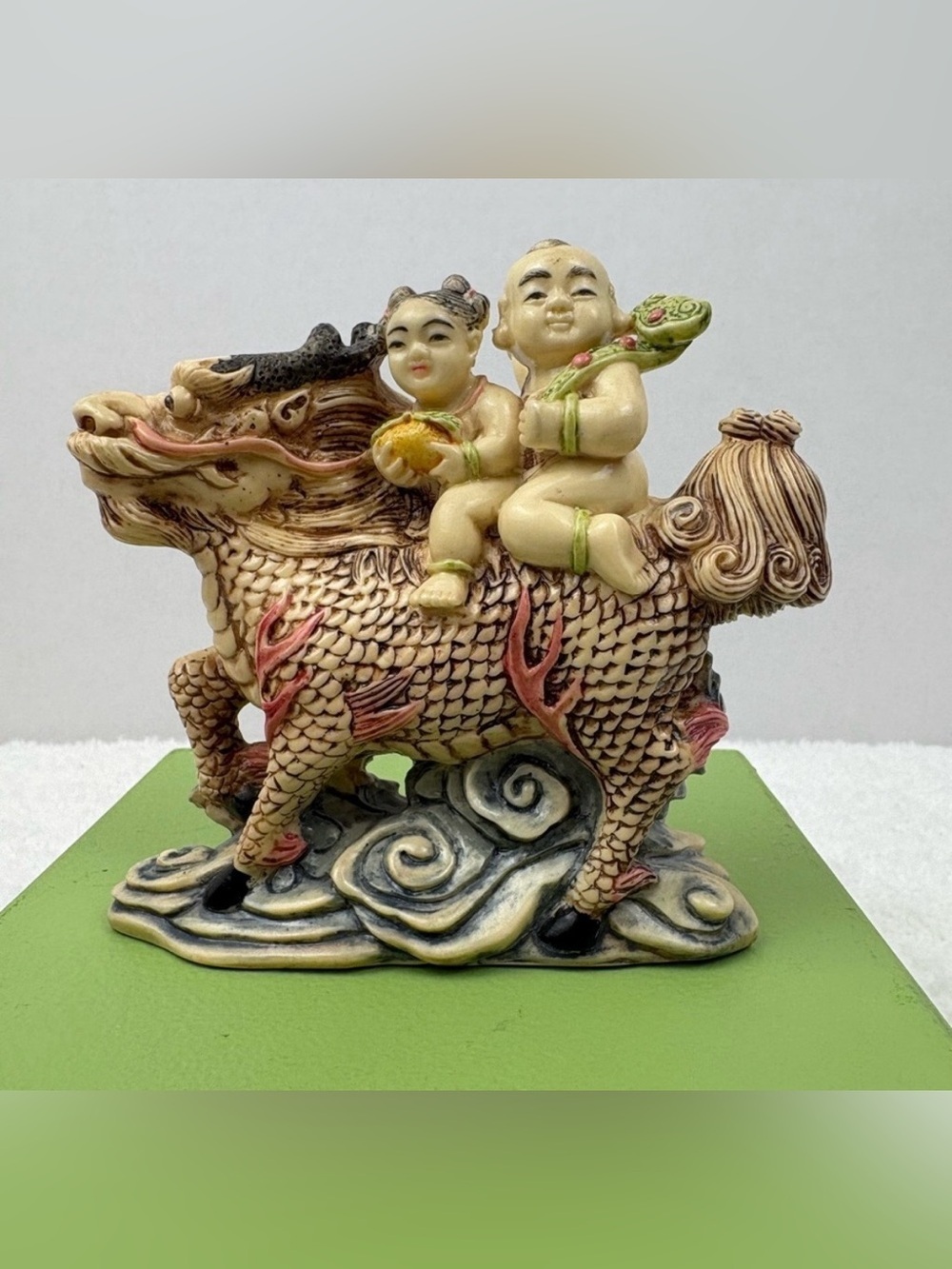 Chinese Figurine Depicting Two Children Riding a Mythical Creature